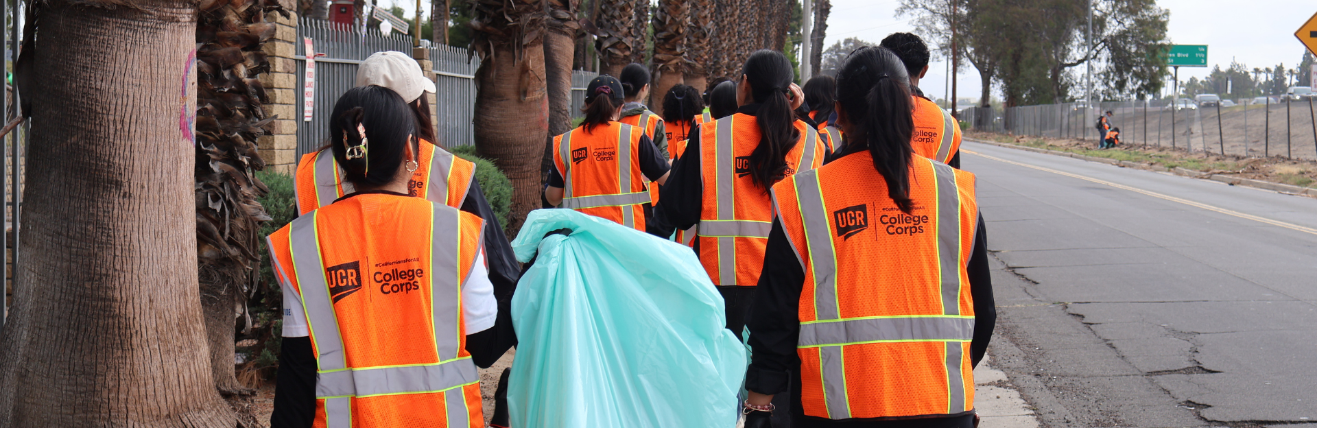 Students carrying trash. 